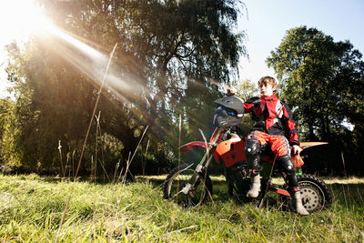 12 year old boy having a break on his off road motorbike