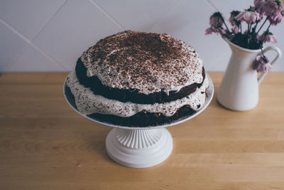 High angle view of chocolate cake on cakestand at table