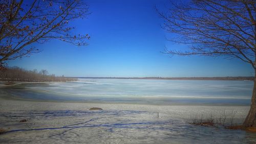 Scenic view of sea against clear blue sky