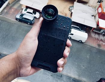 Midsection of man photographing with mobile phone