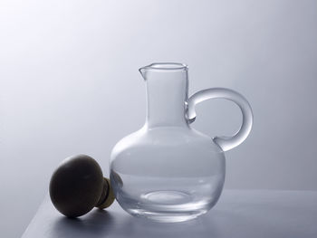 Close-up of glass jar against white background