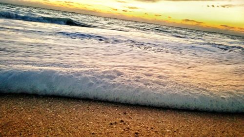 Scenic view of beach against sky during sunset