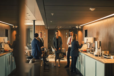 Financial advisors talking during coffee break in cafeteria at legal office