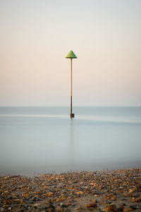 Scenic view of sea against clear sky during sunset