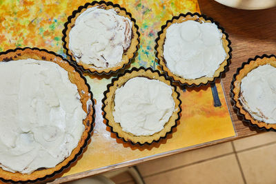 Manufacturing process round cream pie with chocolate and strawberries. french recipe