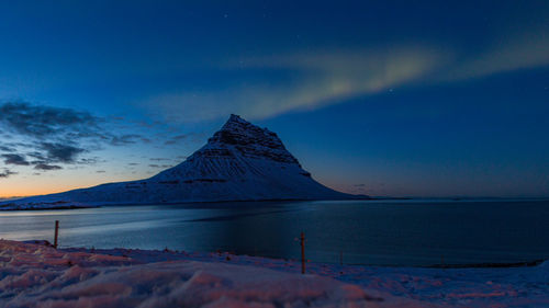 Full frame view of aurora polaris just after sunset above a mountain