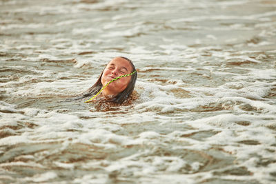 Young woman swimming in sea