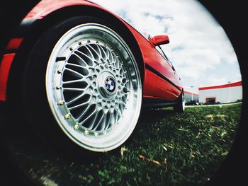 Close-up of vintage car against cloudy sky