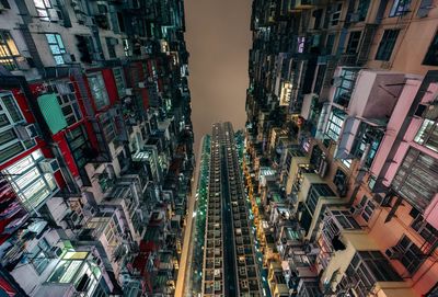 Low angle view of illuminated buildings in city at night