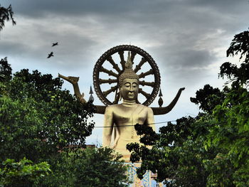 Low angle view of statue against sky