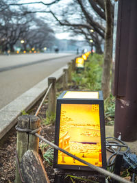 Close-up of yellow telephone on road