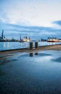 Pier over sea against sky in city