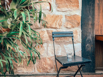 Empty bench against wall