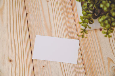 High angle view of open book on wooden table