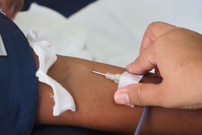 Cropped image of doctor and patient at blood bank