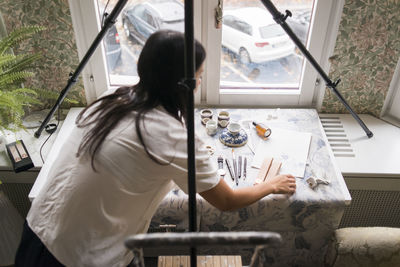 Woman preparing for still life shooting