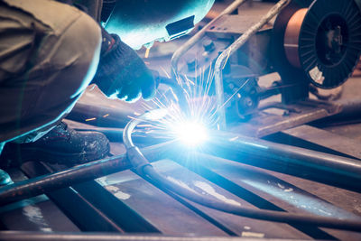 Low angle view of man welding in factory