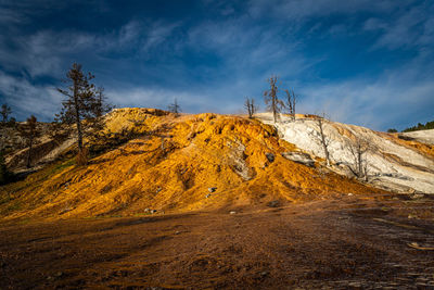 Scenic view of hill against sky