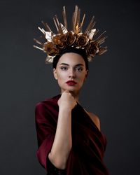 Portrait of woman against black background