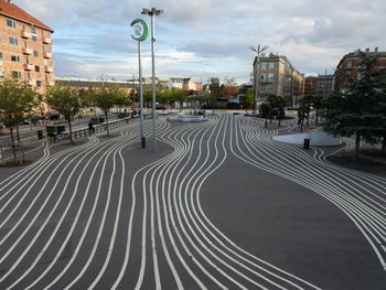 Street amidst buildings in city against sky