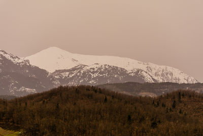 Scenic view of snowcapped mountains against clear sky