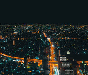 High angle view of illuminated city buildings at night