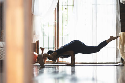 Side view of woman exercising in gym