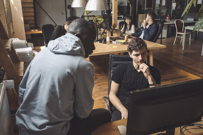 Rear view of people sitting on chair