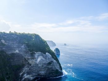 Scenic view of rock formation in sea against sky