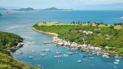 High angle view of boats on sea shore against sky