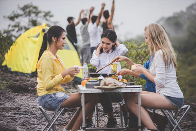 Rear view of people eating food