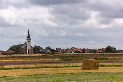 Built structure on field against sky