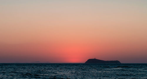 Scenic view of sea against romantic sky at sunset