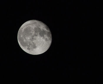 Low angle view of moon against clear sky at night