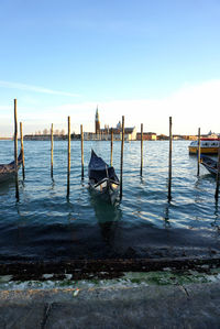 Boat moored in sea against sky