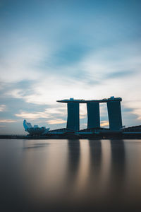 Built structure by sea against sky