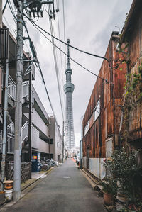 Street amidst buildings against sky in city