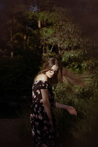 Full length of woman standing in sunlight