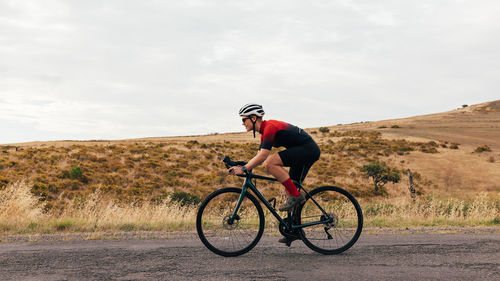 Man riding bicycle on road