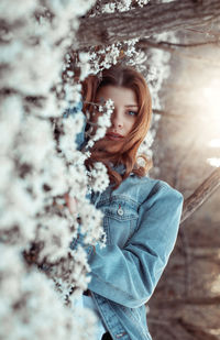 Portrait of woman standing in snow