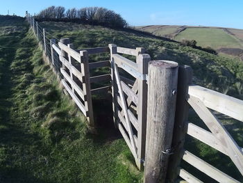 Wooden post on grassy field