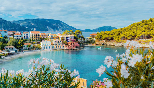 Scenic view of sea and buildings against sky