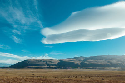 Scenic view of landscape and mountains against sky