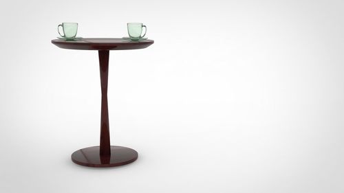 Close-up of electric lamp on table against white background