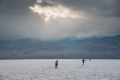 Scenic view of desert against cloudy sky at death valley national park