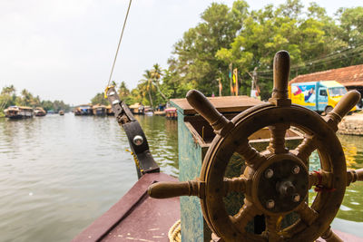 Close-up of wheel in boat on lake