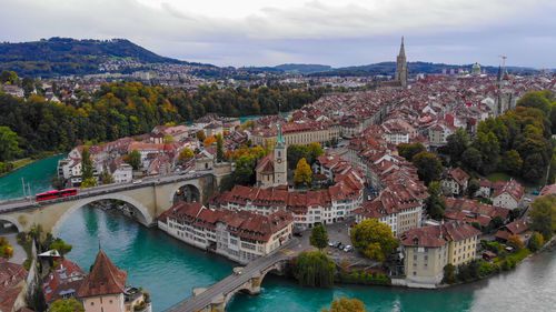 Aerial view of bridge over river amidst buildings in city