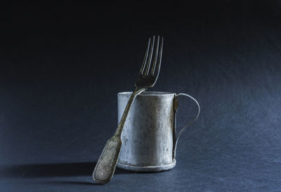 Old aluminum cup and fork