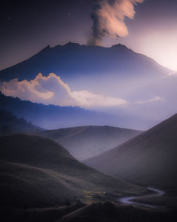 Scenic view of mountains against sky at night