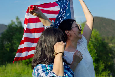 Women with usa flag, celebration of patriotic american national holiday 4th of july independence day